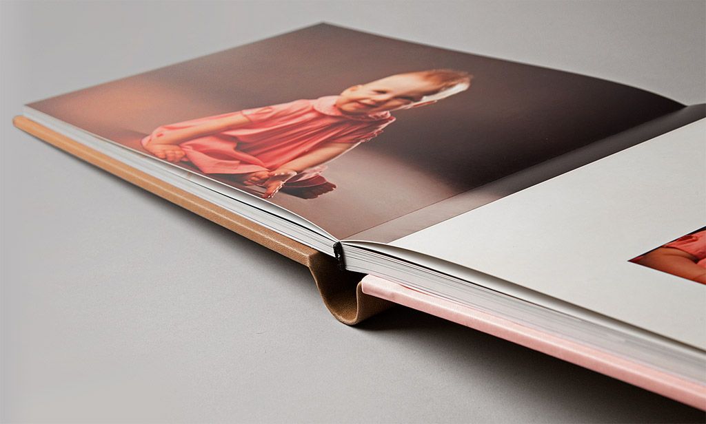 Close-up view of modern hardcover book with black and red gradient design on white surface.