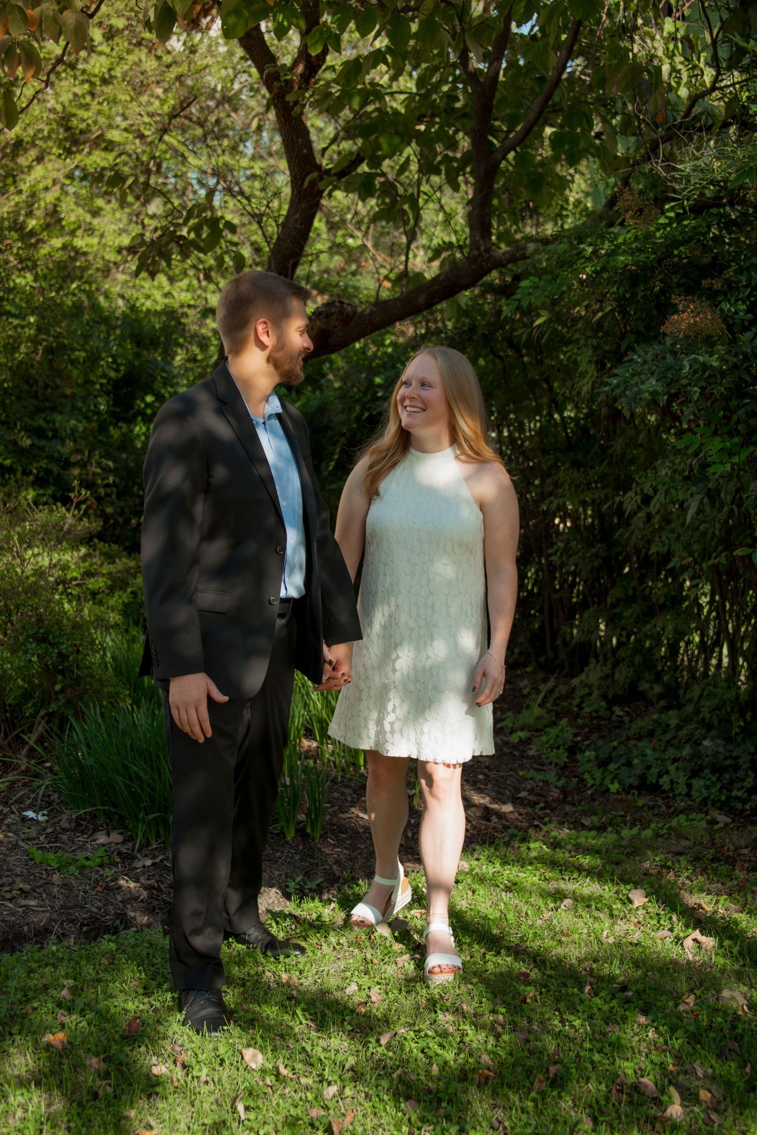 Young couple walking and smiling, looking at each other