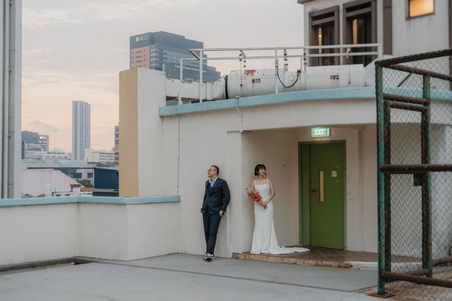 A rooftop scene in an urban setting with modern buildings and skyline visible in the background.