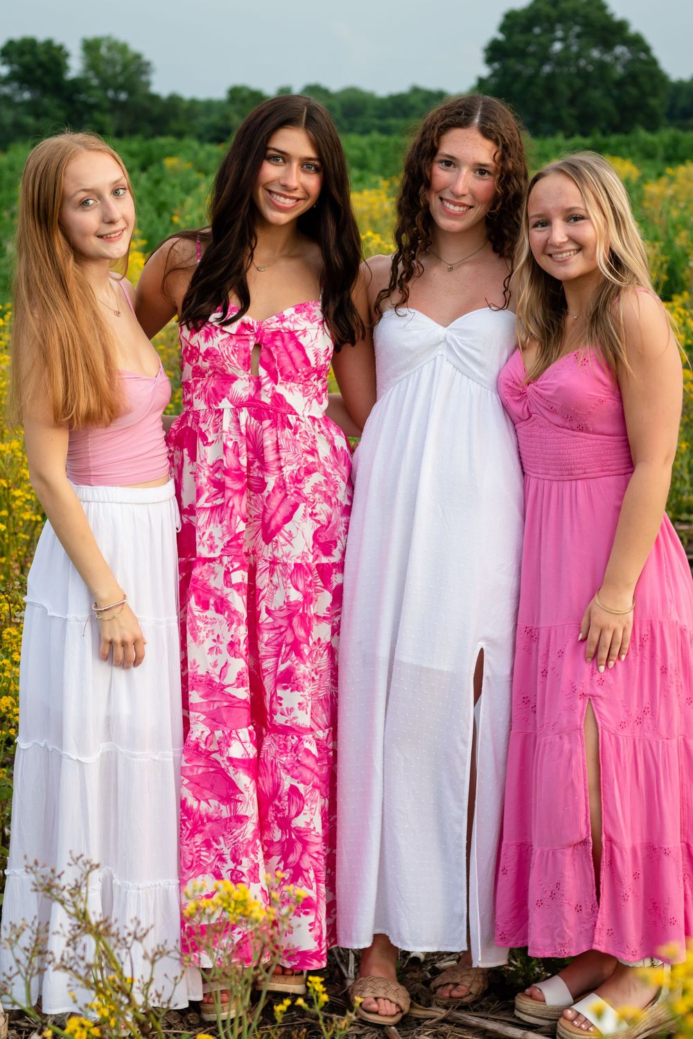 Natural senior photos in a garden. Senior photos with wildflowers. Portraits in a field of flowers. Photos in a flower field with friends