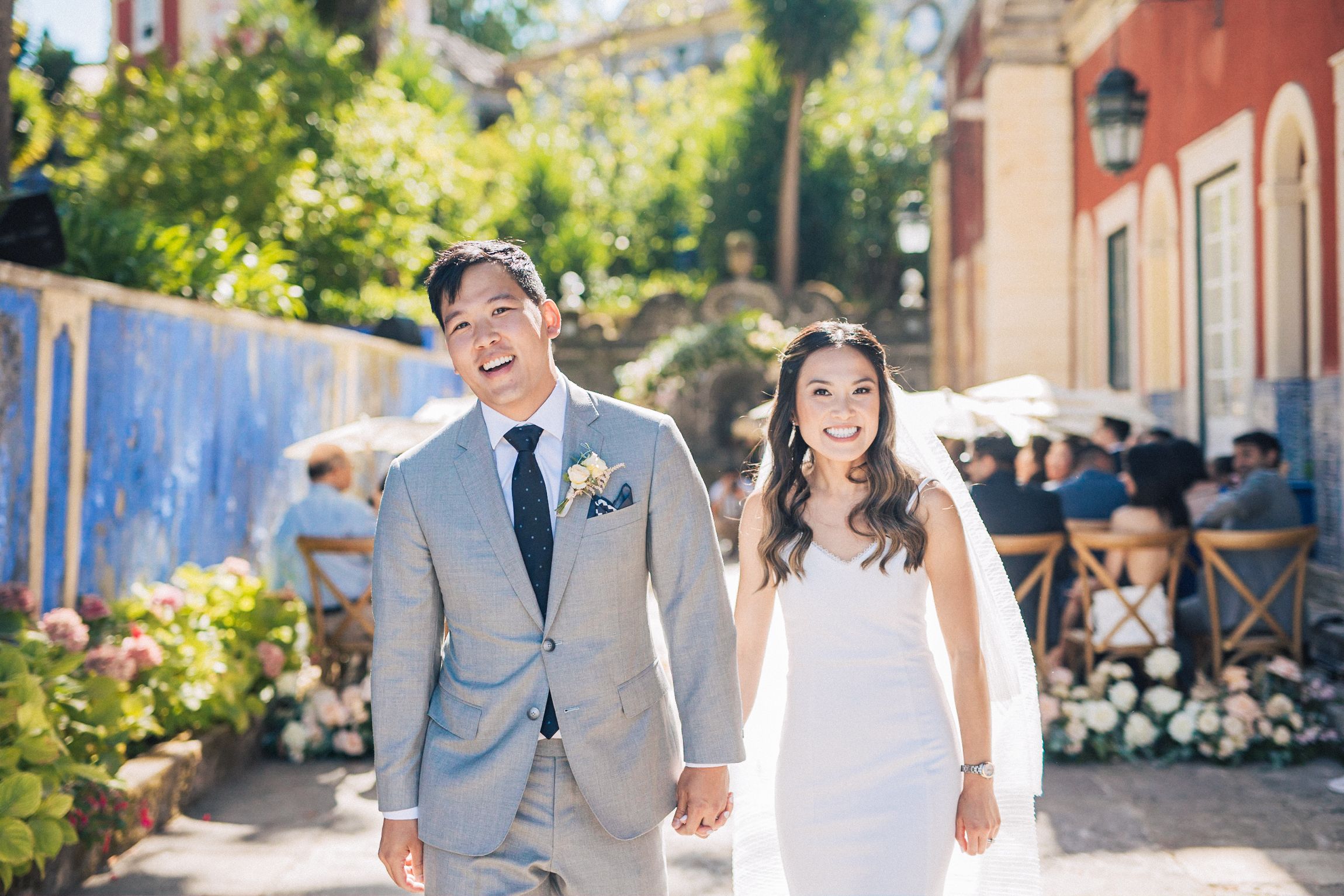 Asian-American couple smiling in wedding ceremony at Palácio Fronteira courtyard in Lisbon photo by a Portugal wedding photographer