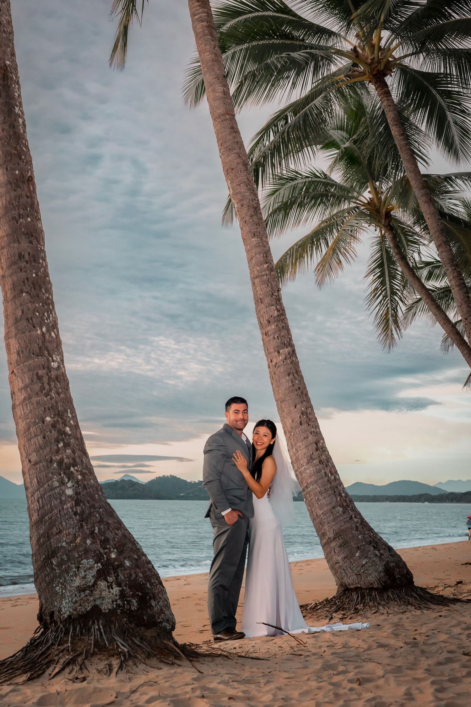 A romantic sequence of intimate moments between a couple in a lush green garden setting with red roses.