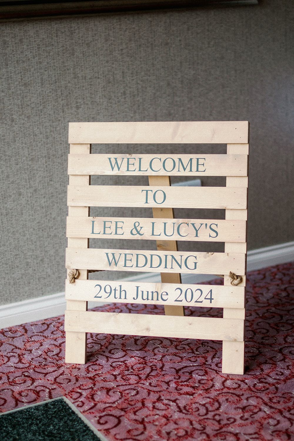 Rustic wooden welcome sign for Lee & Lucy's wedding dated June 29th 2024.