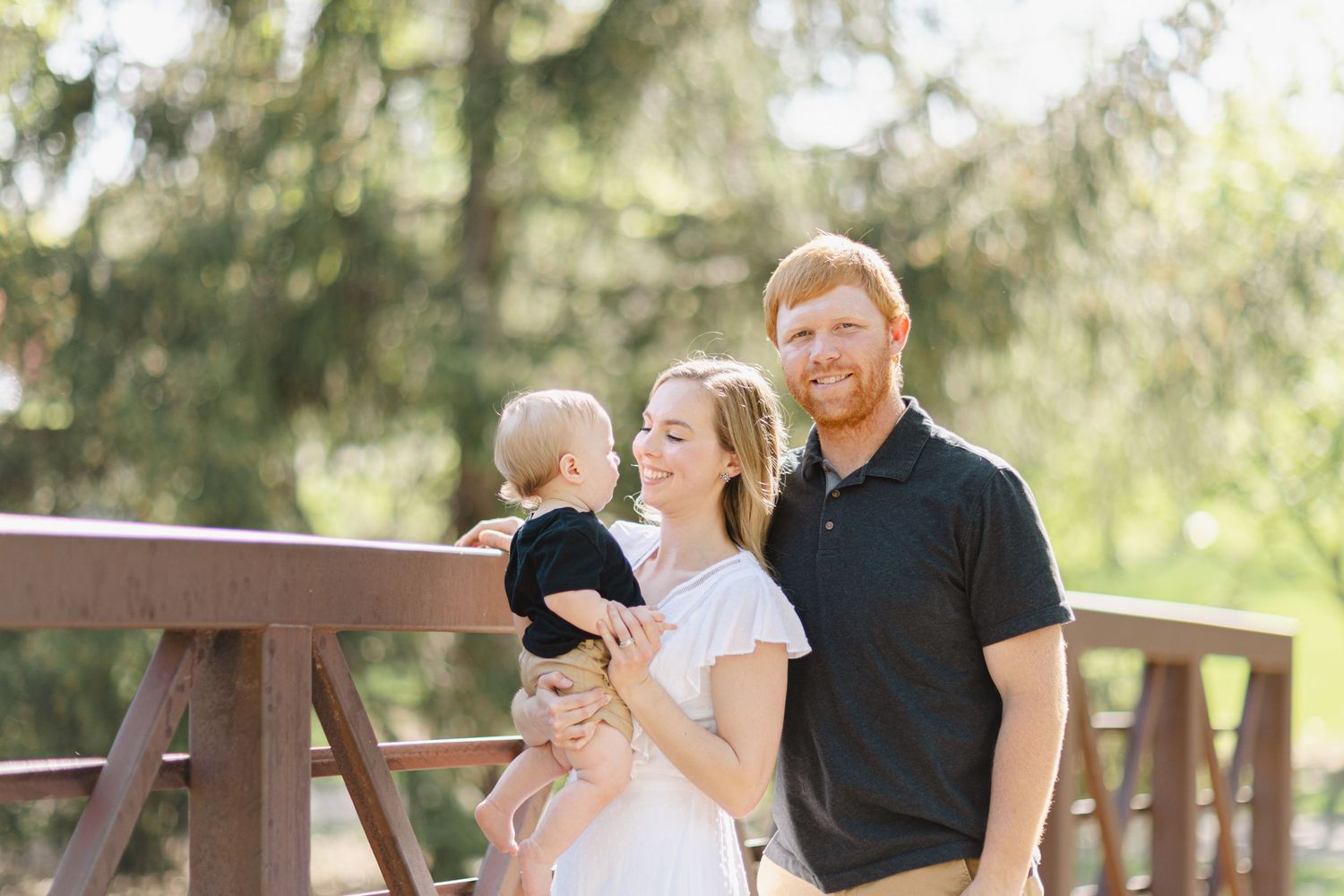 Mother and father hugging their young baby boy during a mother's day family photography session in Minneapolis