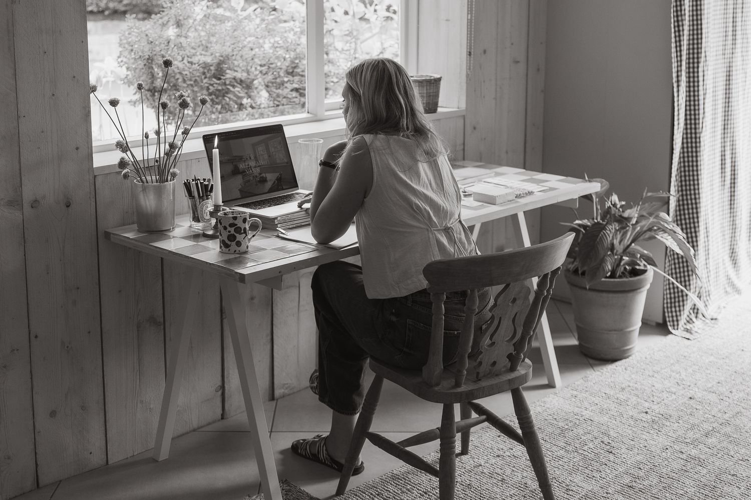A black and white photo montage shows multiple people working at desks in a vintage office setting.