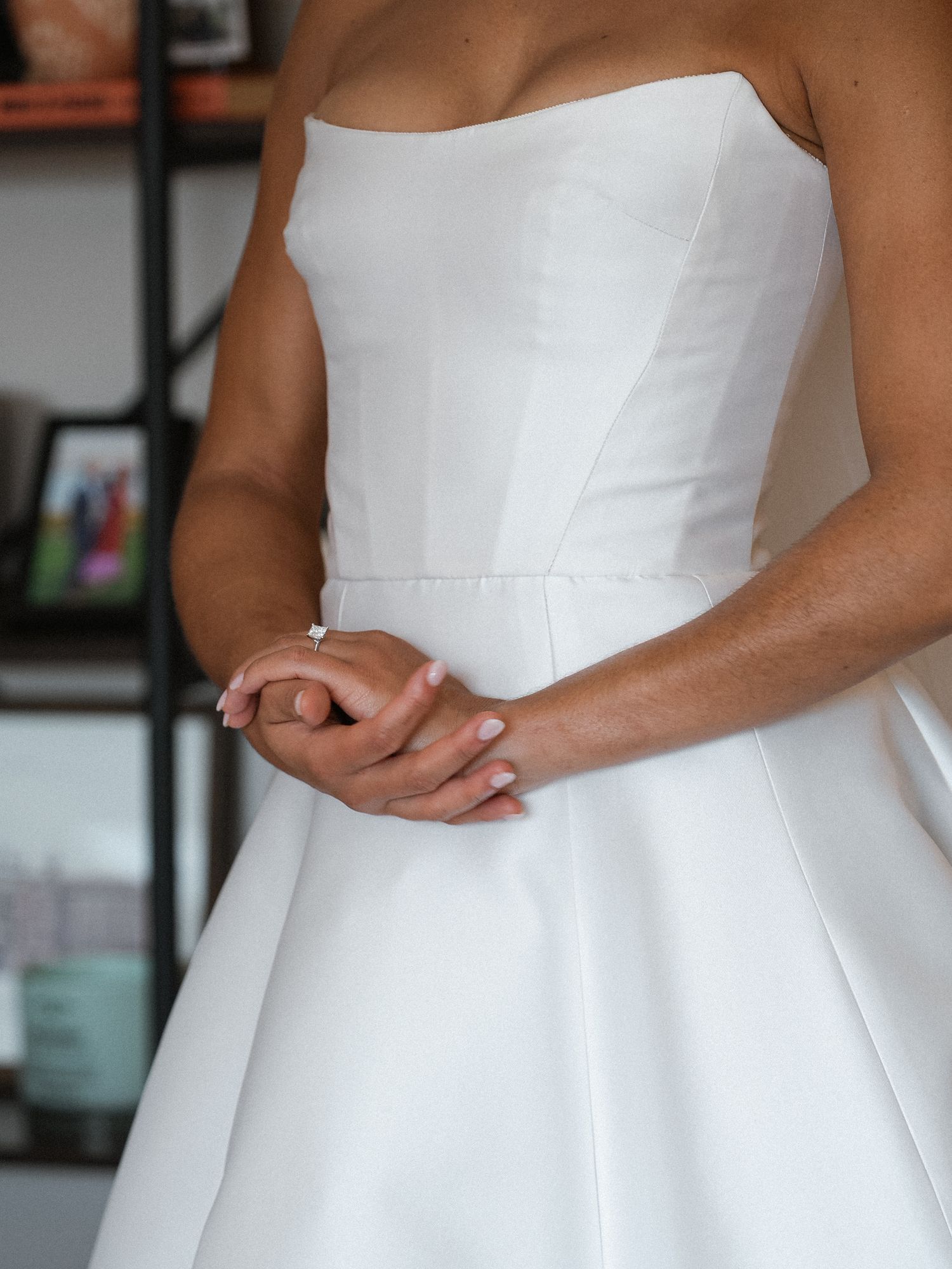 Close-up details of an elegant white strapless wedding gown with a structured bodice.