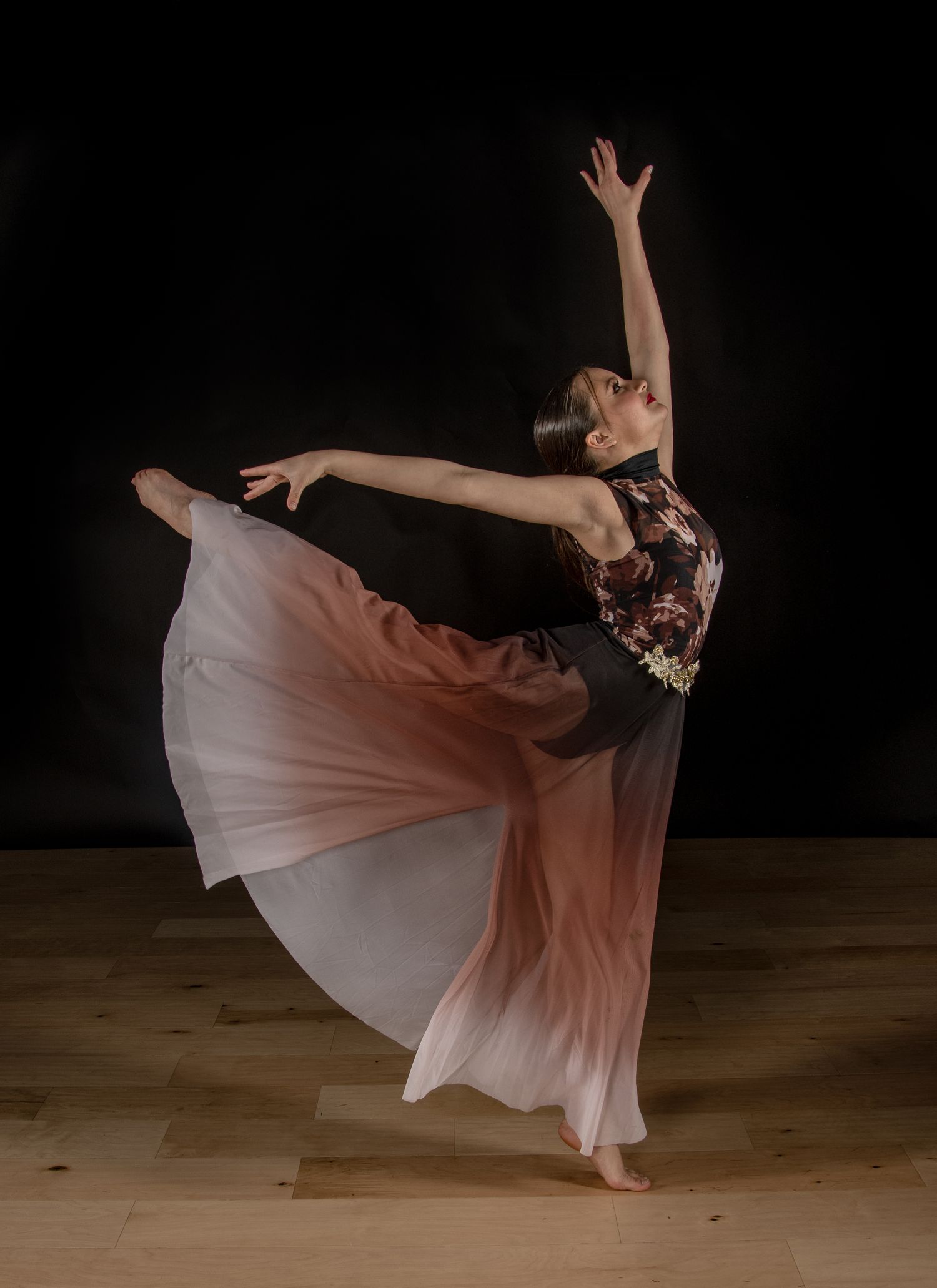 A dancer in beige clothing performs a series of graceful lunging movements against a dark background.