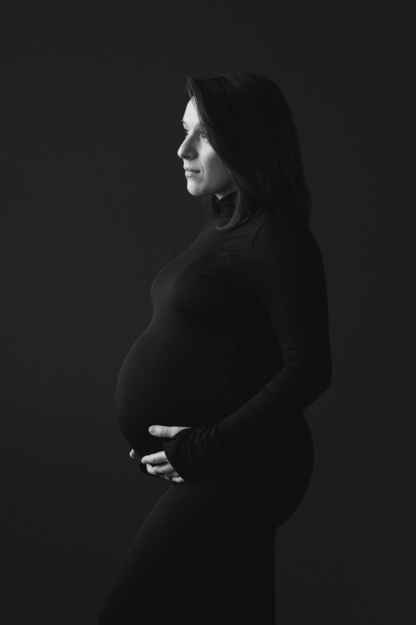 Black and white maternity silhouette portrait photographed in a Norfolk studio