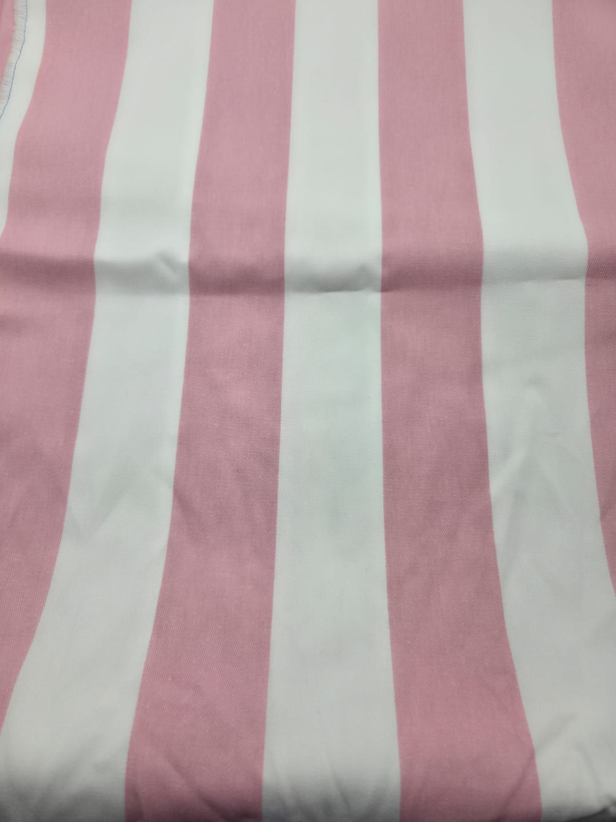 Pink and white striped textile pattern showing soft alternating lines.