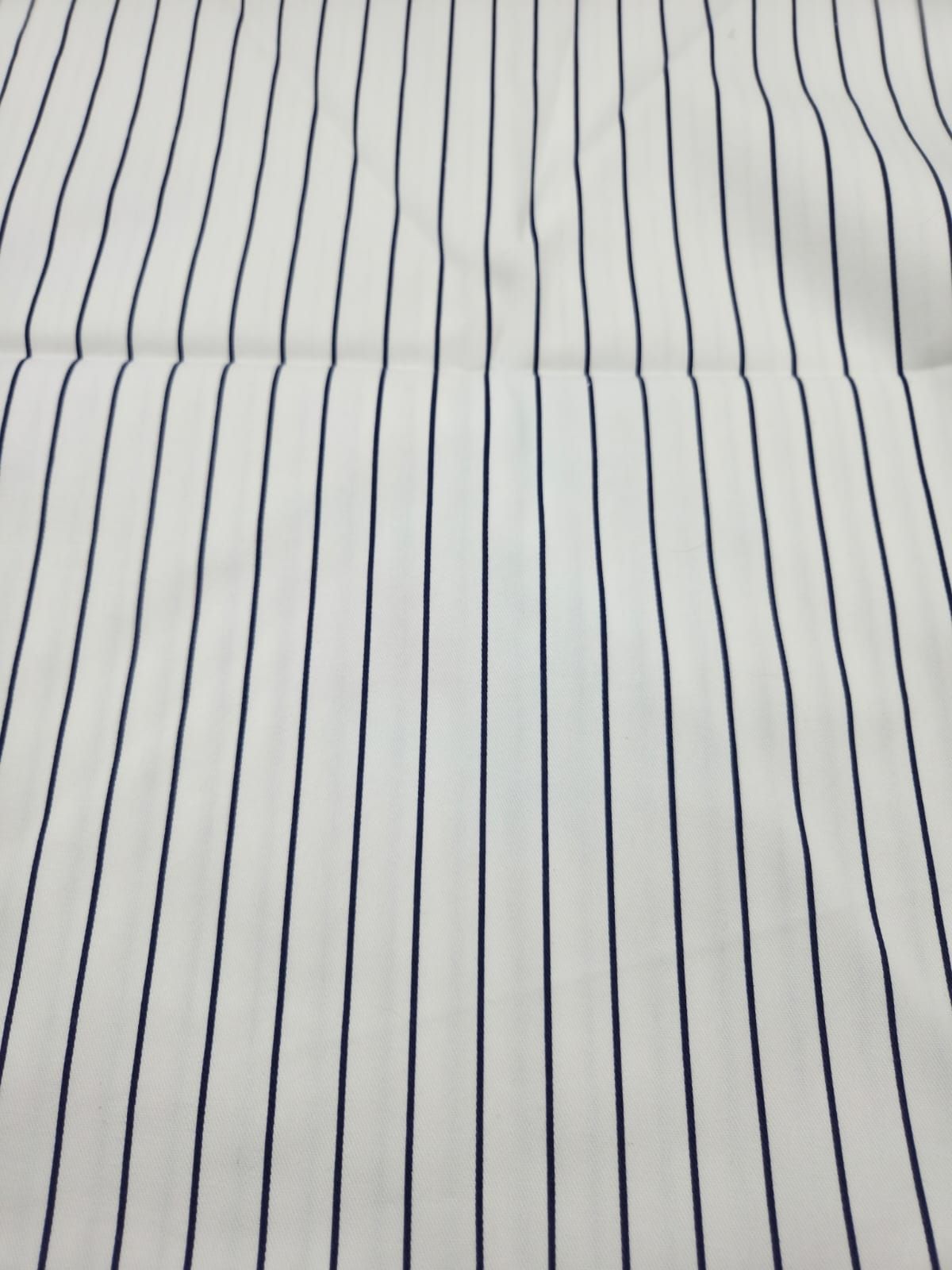 Abstract pattern of vertical wavy black lines on white background creating an optical illusion effect.