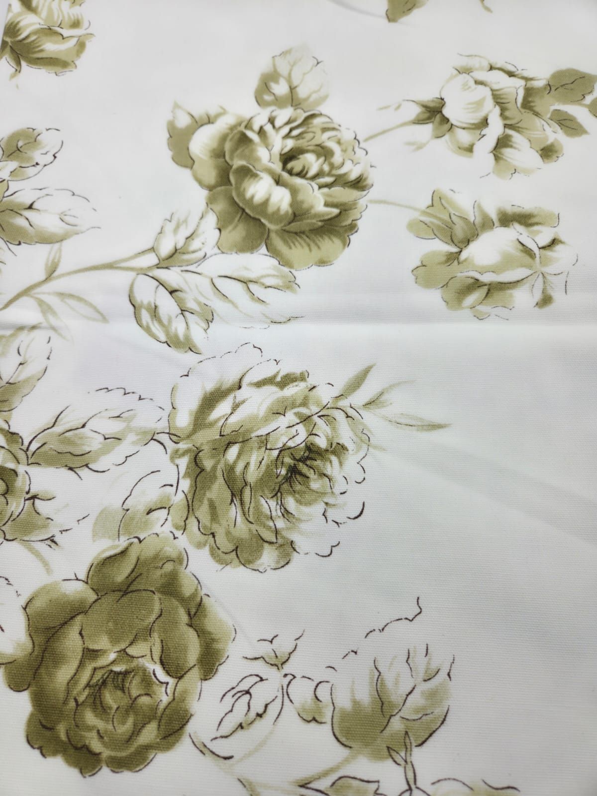 Vintage floral fabric pattern with large olive green roses and leaves on white background.
