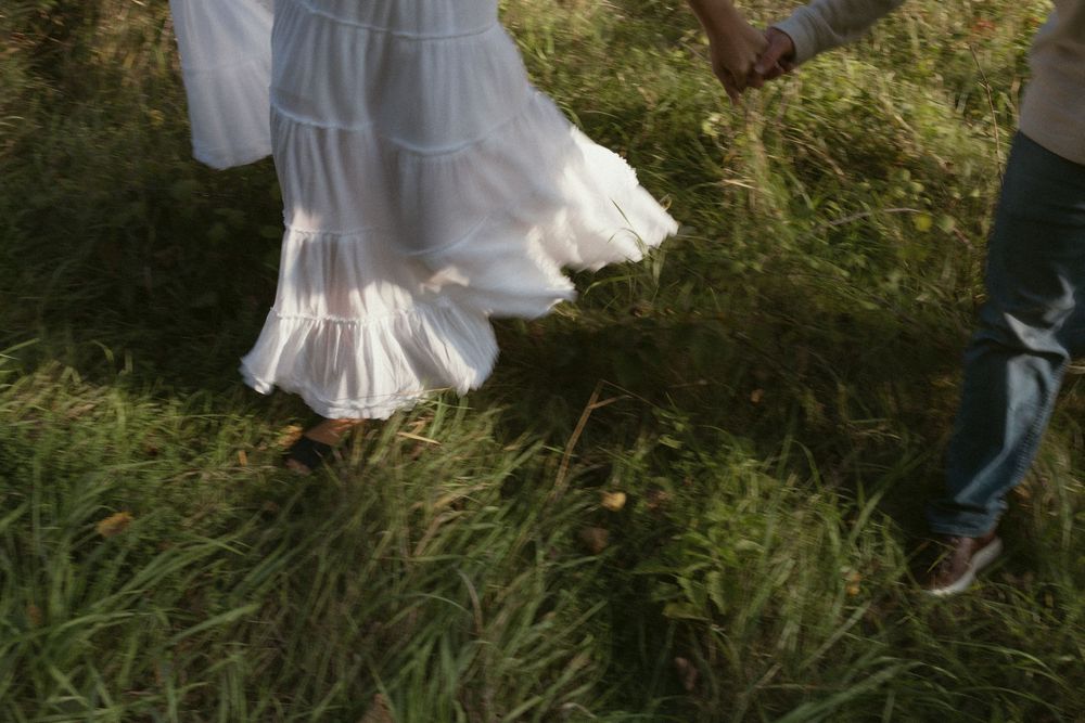 People walking through tall grass in a natural outdoor setting.