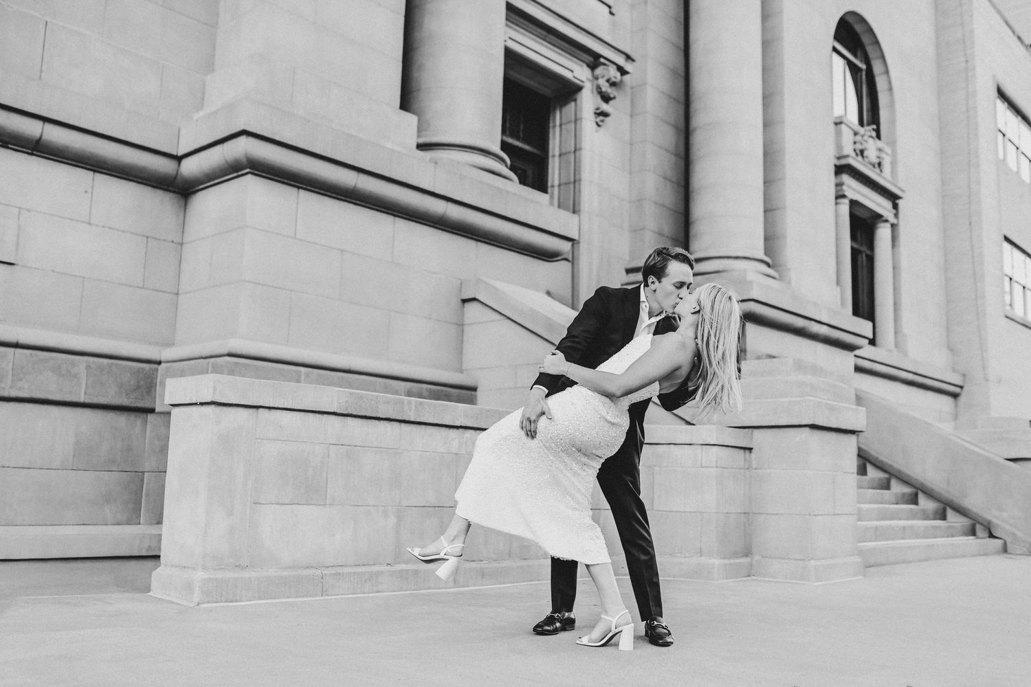 Cinematic engagement photos of couple dipping in downtown Dallas arts district