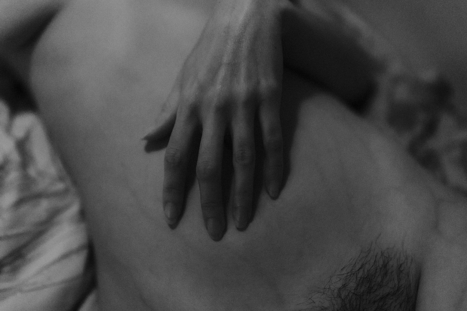 A series of black and white artistic photographs showing abstract close-up views of human forms in shadow.