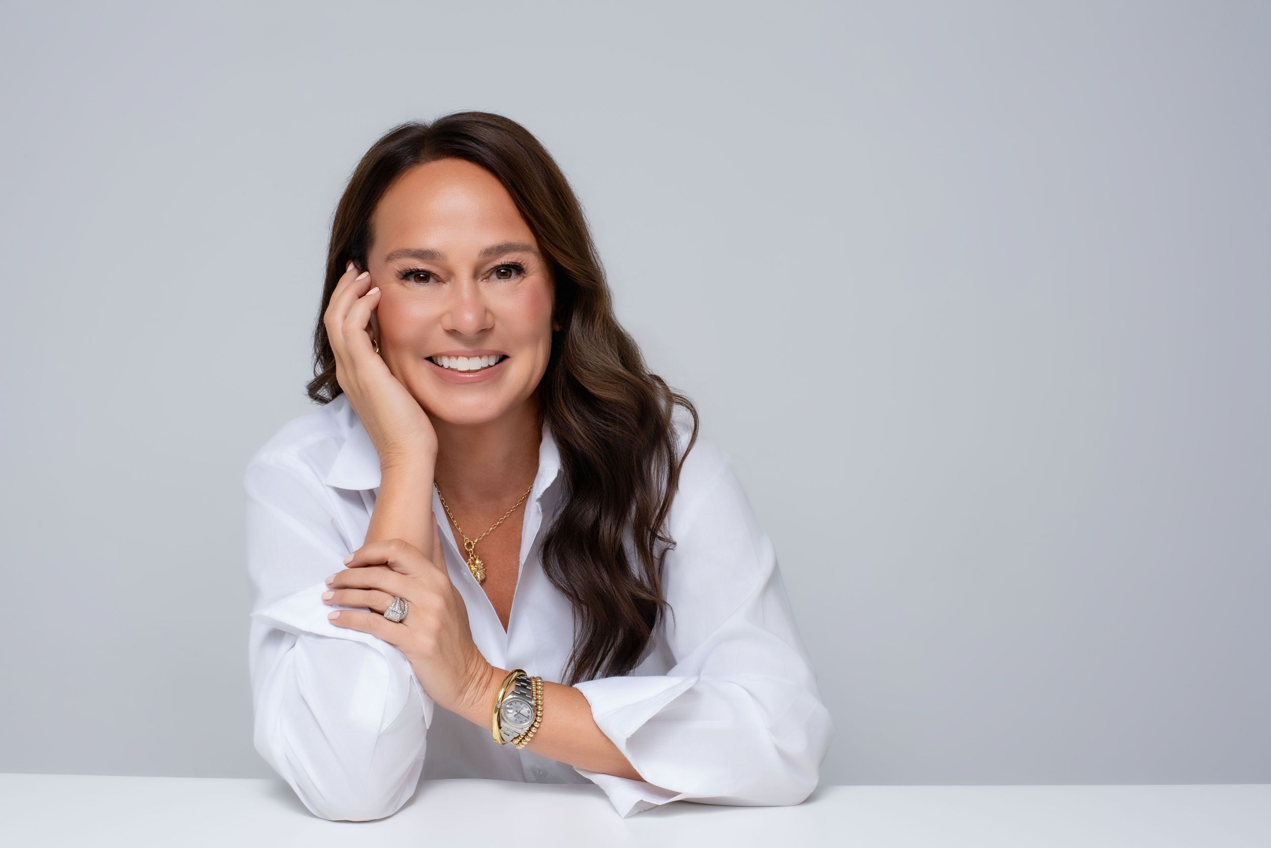 Professional business portrait of a confident woman in a modern studio, styled for a personal brand and corporate presence.