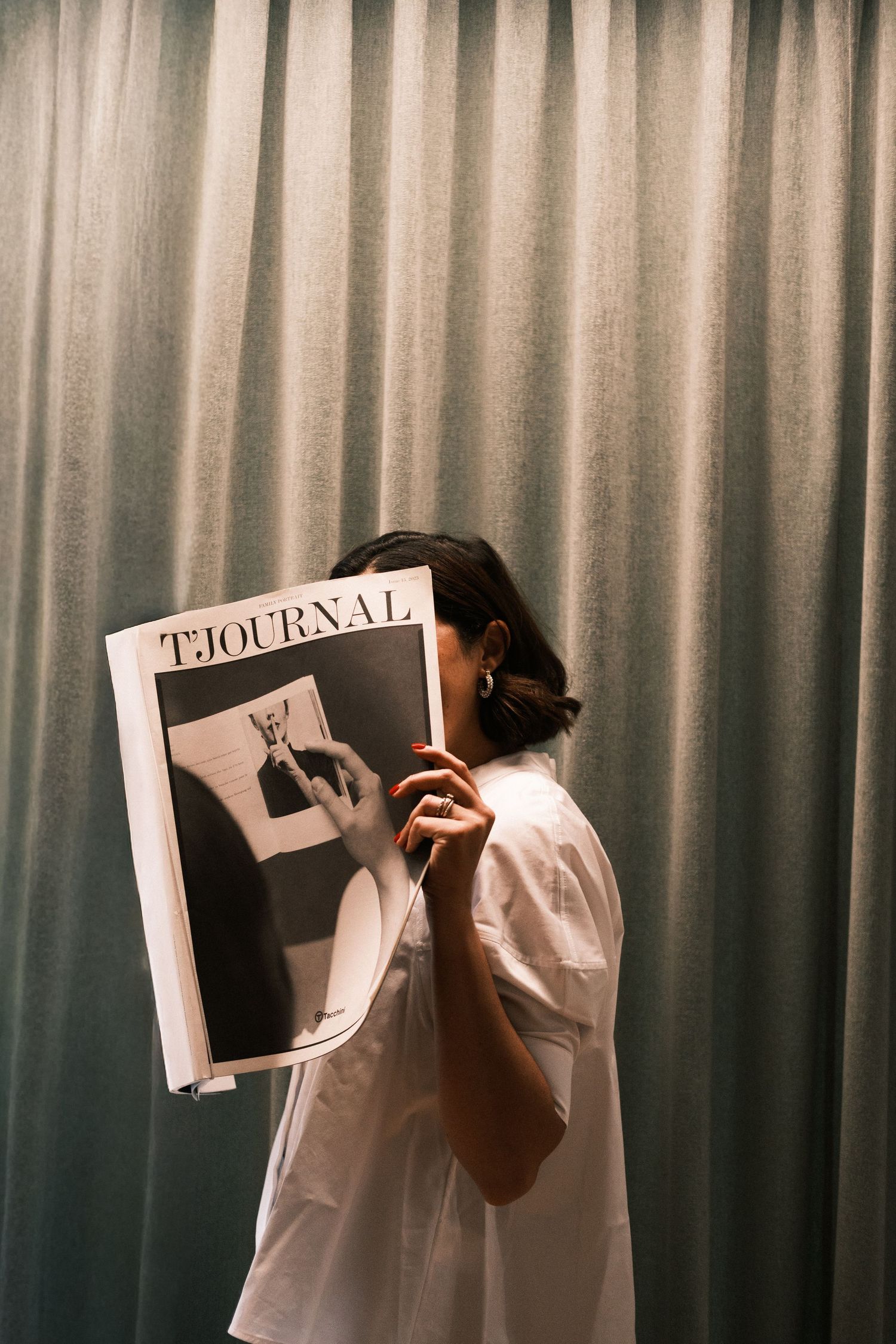 A sequence of silhouettes reading a journal against a curtained backdrop.