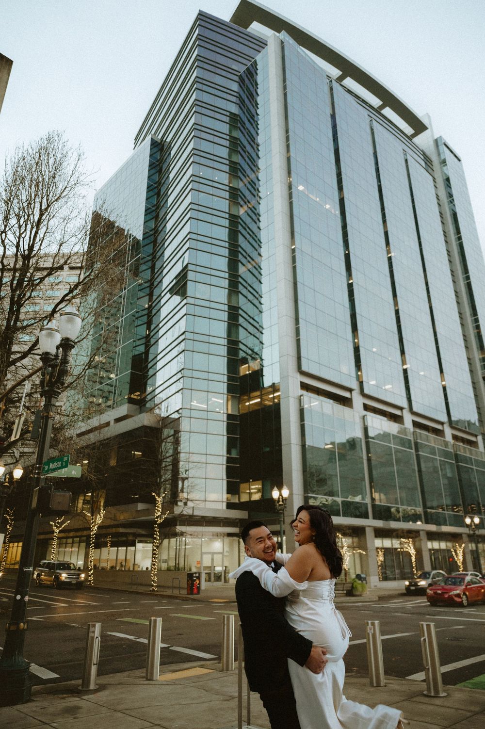 Modern glass office building exterior with reflective windows and sleek architectural design in an urban setting.