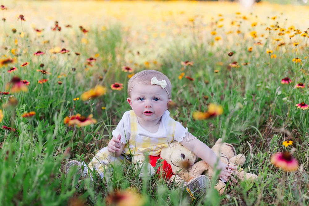 A series of autumn photos showing someone lying in grass with scattered red and orange maple leaves on the ground.
