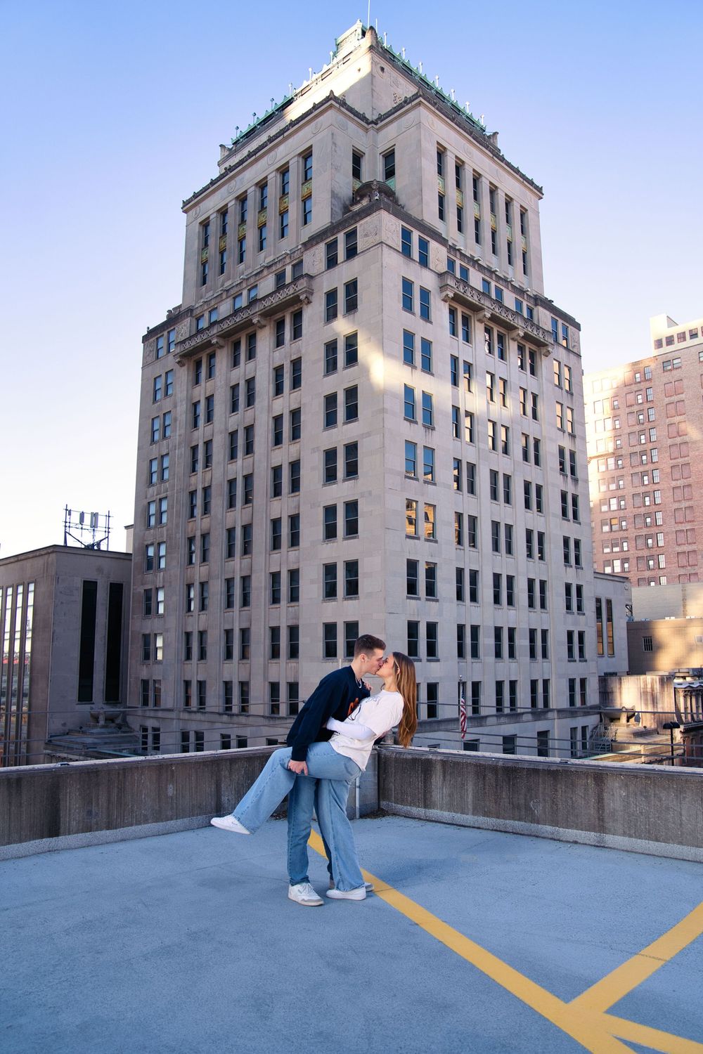 Downtown engagement locations for couples at downtown Cincinnati. Couple dip kissing on a rooftop: Cincinnati Wedding Photographer