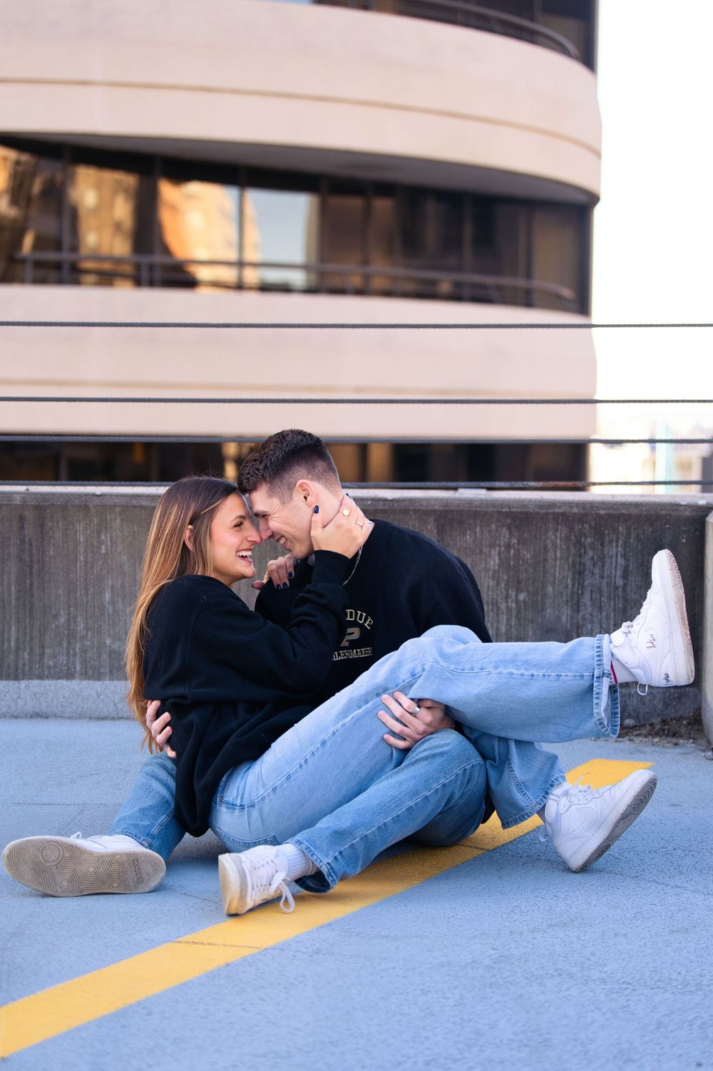Downtown engagement locations for couples at downtown Cincinnati. Couple snuggled up on rooftop: Cincinnati Wedding Photographer