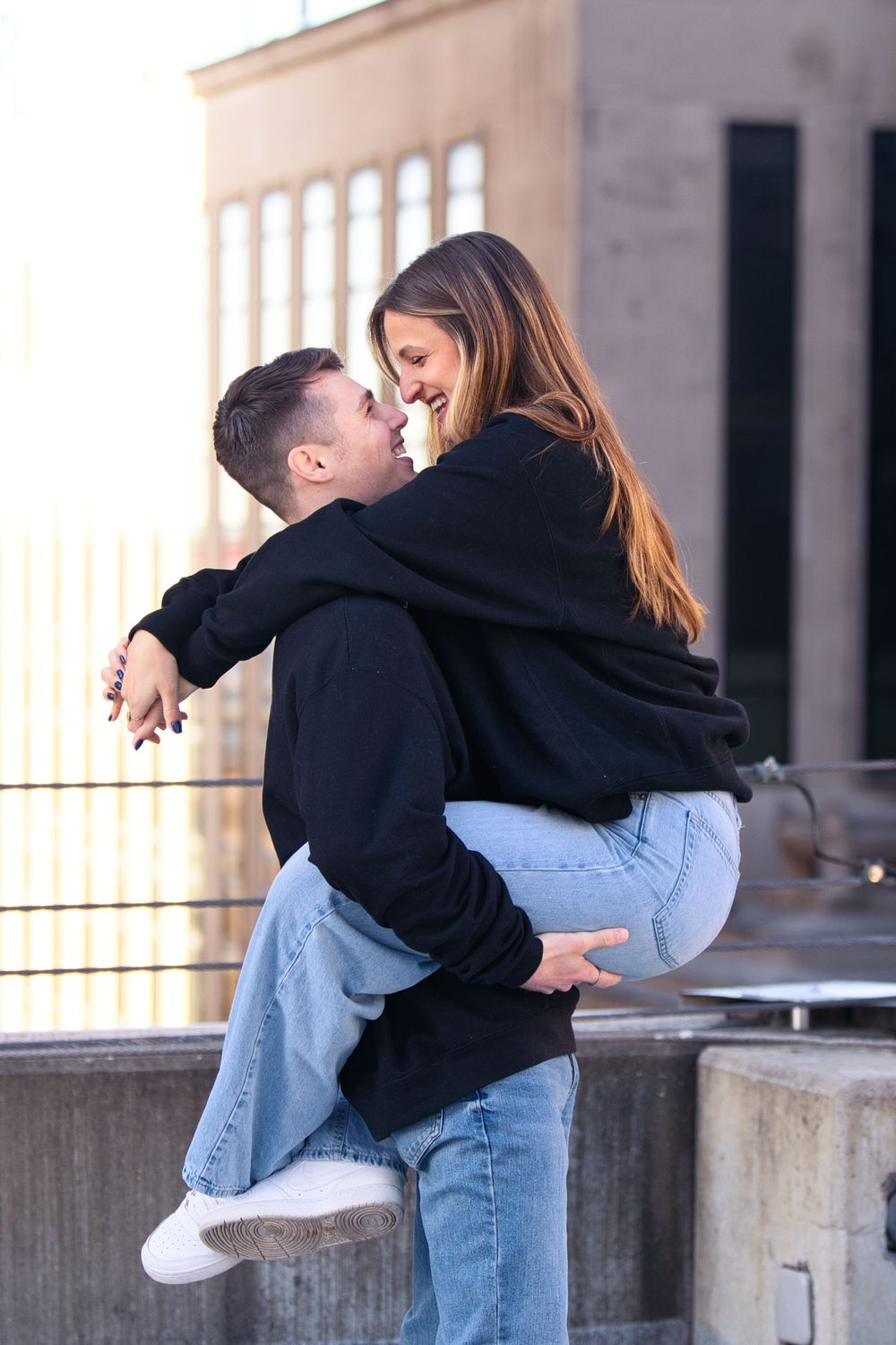 Downtown engagement locations for couples at downtown Cincinnati. Couple holding each other on rooftop: Cincinnati Wedding Photographer