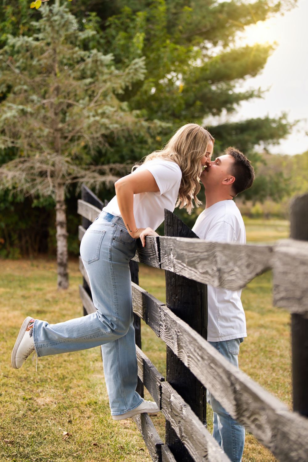 Best engagement locations for couples in Cincinnati. Couple kissing by the fence at Historic White Oak Farm: Cincinnati Wedding Photographer