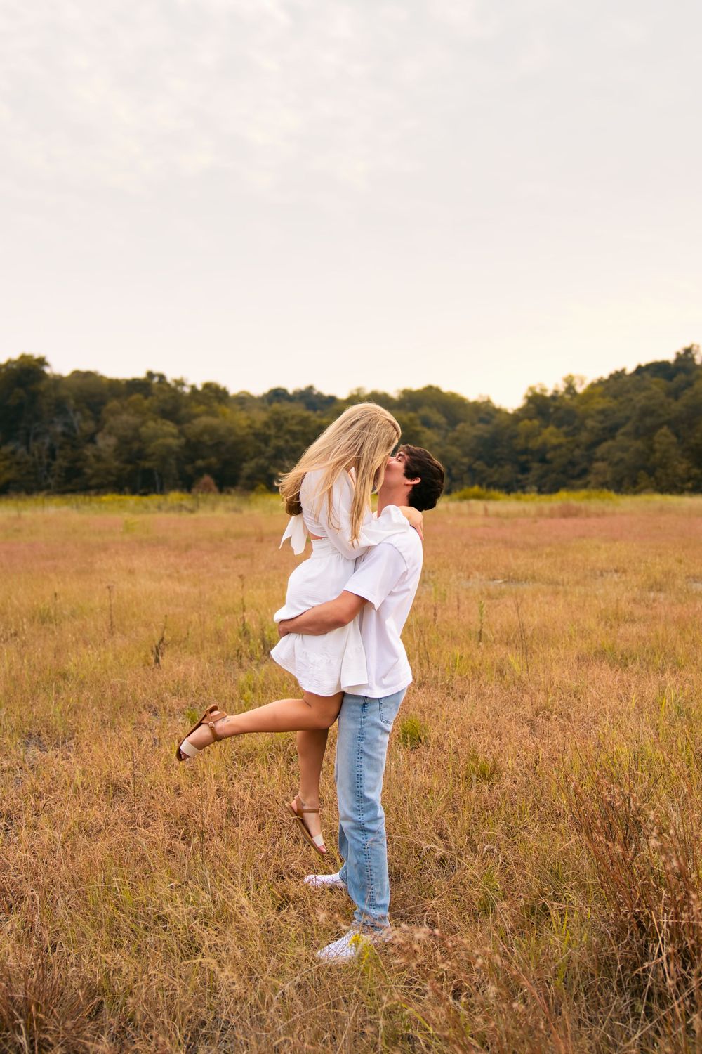 Best engagement locations for couples in Cincinnati. Couple kissing in the tall grass of East Fork Park: Cincinnati Wedding Photographer