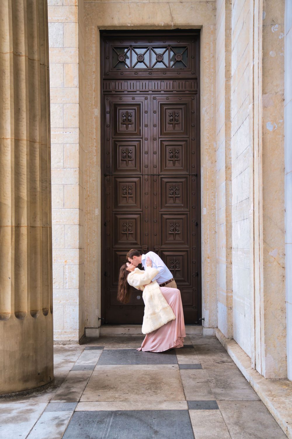 Downtown engagement locations for couples at downtown Cincinnati. Couple dip kissing in a doorway: Cincinnati Wedding Photographer