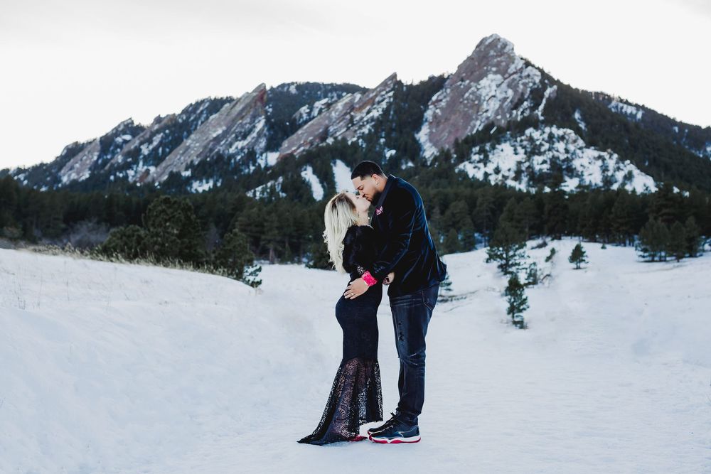 Snow-covered mountain landscape with people enjoying winter activities.
