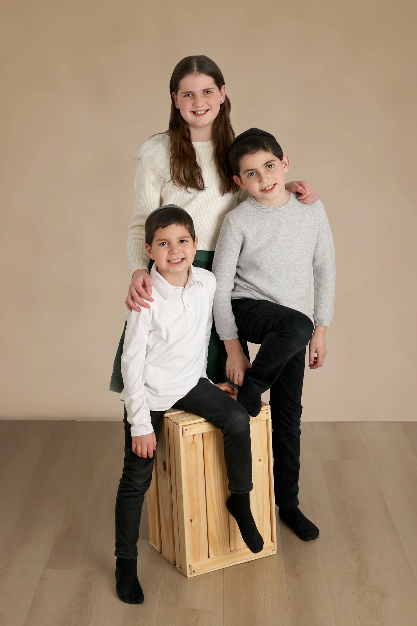portrait of siblings posing together taken at Gitty Strauss Photography studio in Lakewood, New Jersey