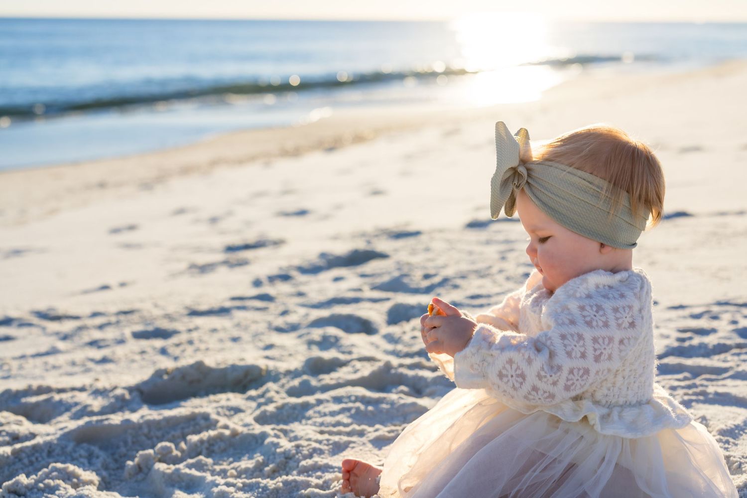 A joyful family moment captured in a series of candid beach photos with a baby, showing love and laughter by the ocean.
