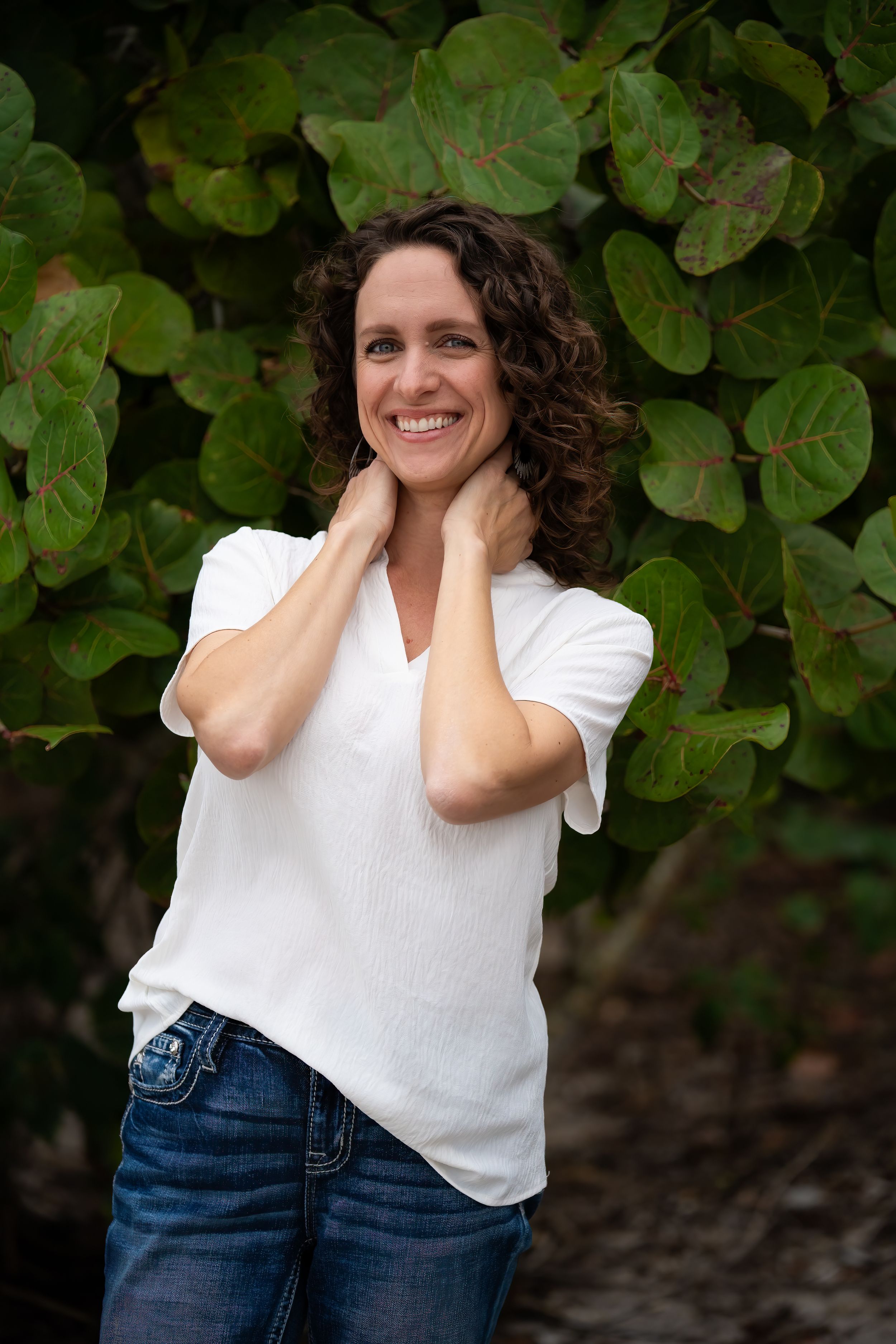 Casey Thomas photography posing in front of the hedge of DuBois park in Jupiter, Florida.