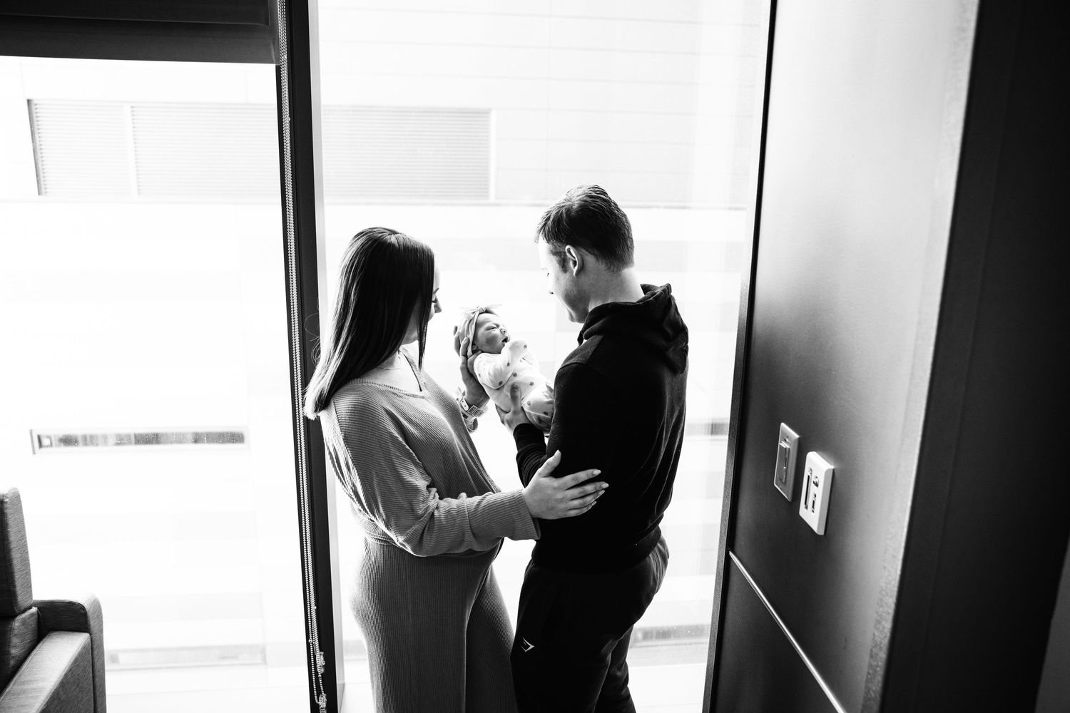 Black and white photo series showing silhouettes of people in doorways and hallways creating a dramatic visual sequence.