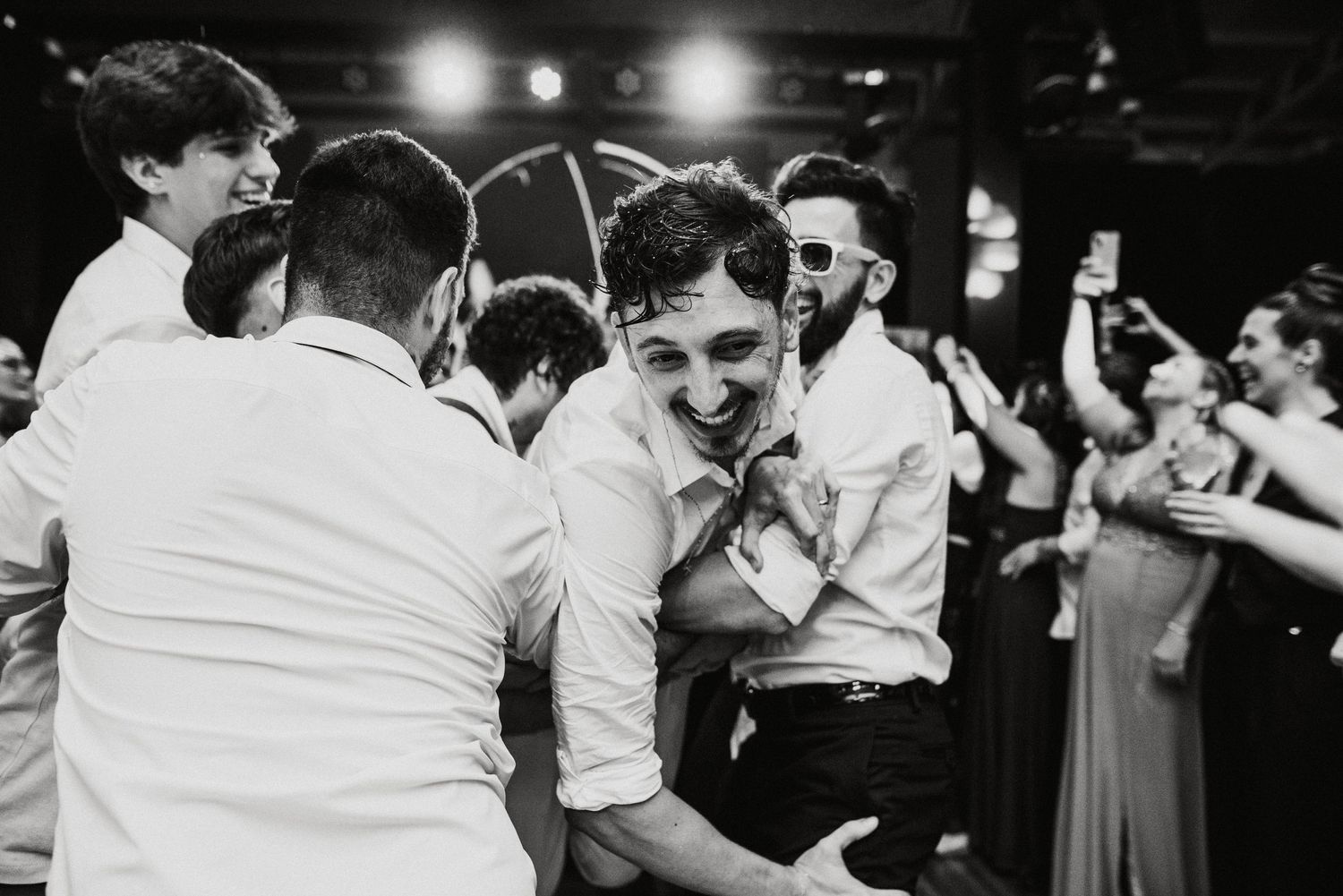 Wedding reception dance floor filled with celebrating guests.