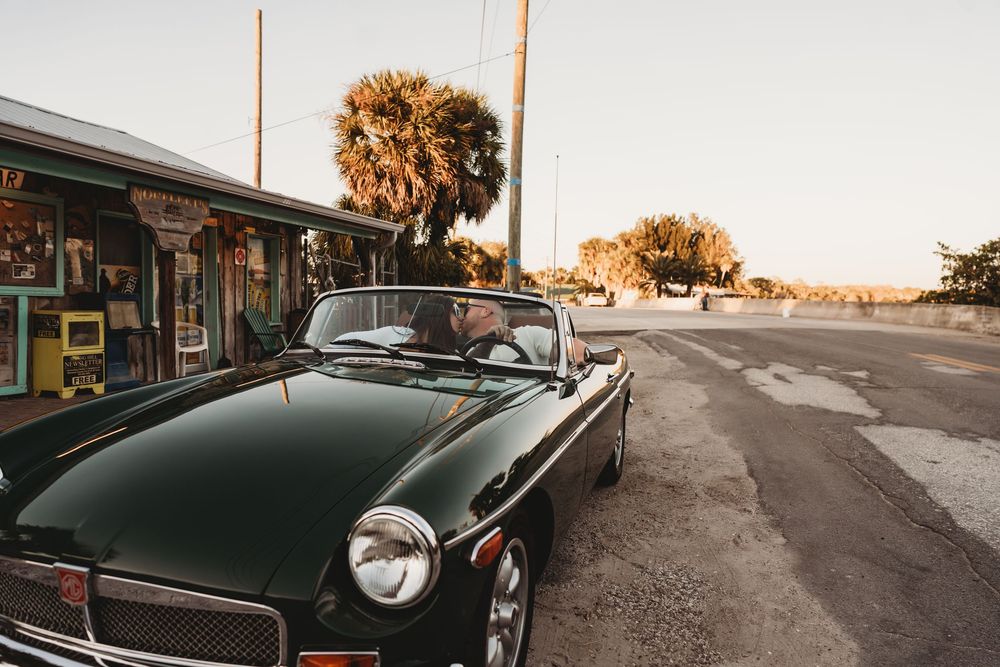 Old Florida–inspired engagement session in Aripeka with vintage car and warm sunset light