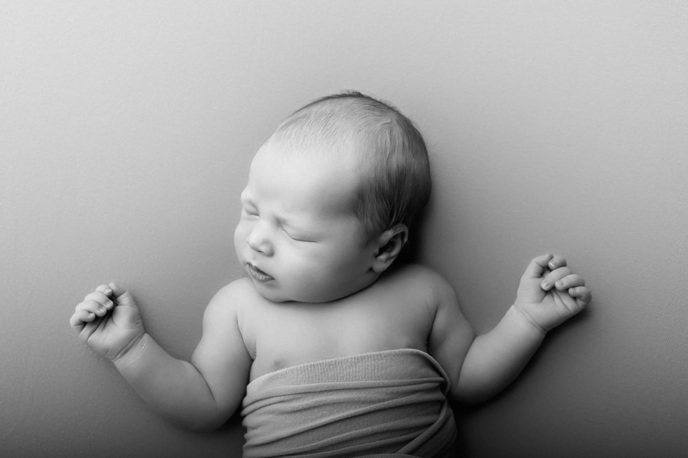 Newborn posing by kara jade photography