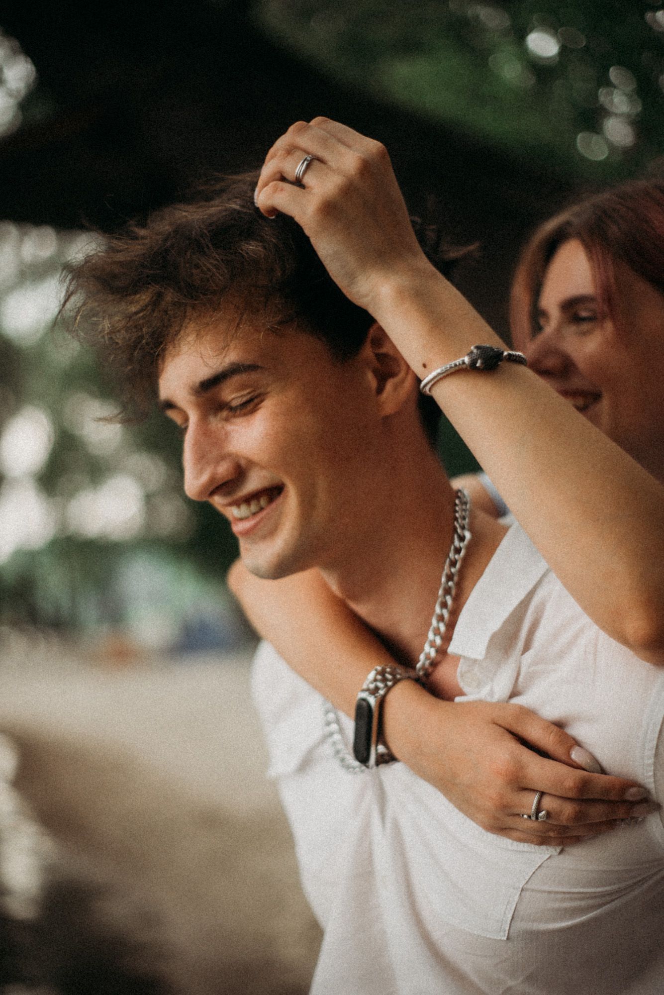 A couple in nature – candid couple photoshoot, the man is laughing.