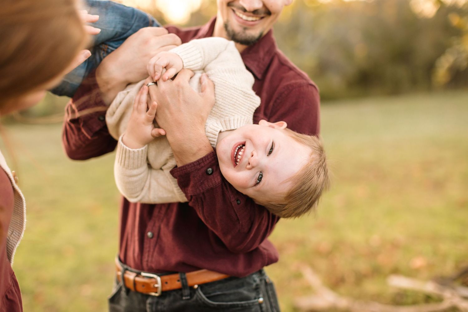 Family portraits with playful poses in autumn outdoor setting.