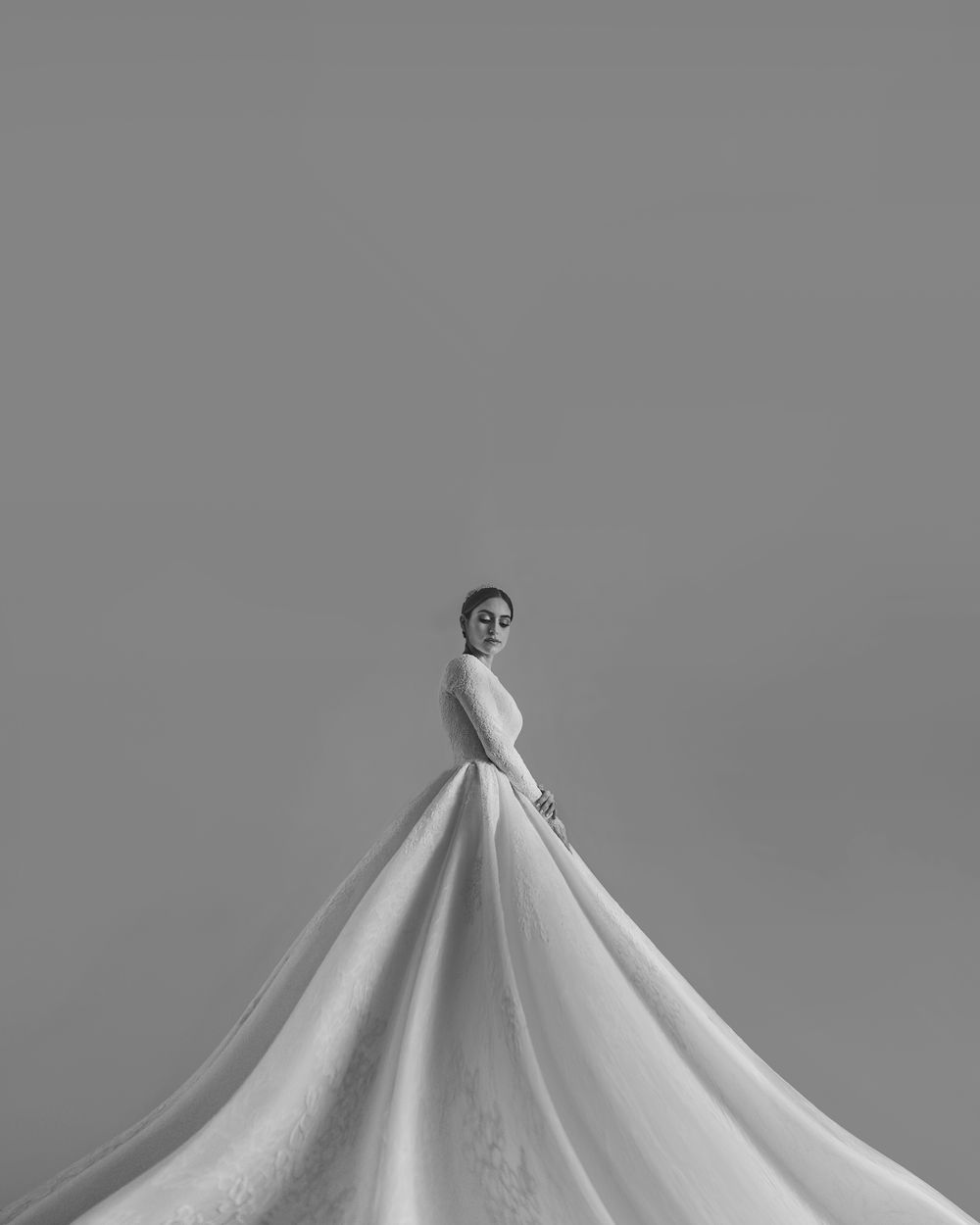 Dramatic black and white photo showcasing full ballgown wedding dress silhouette.