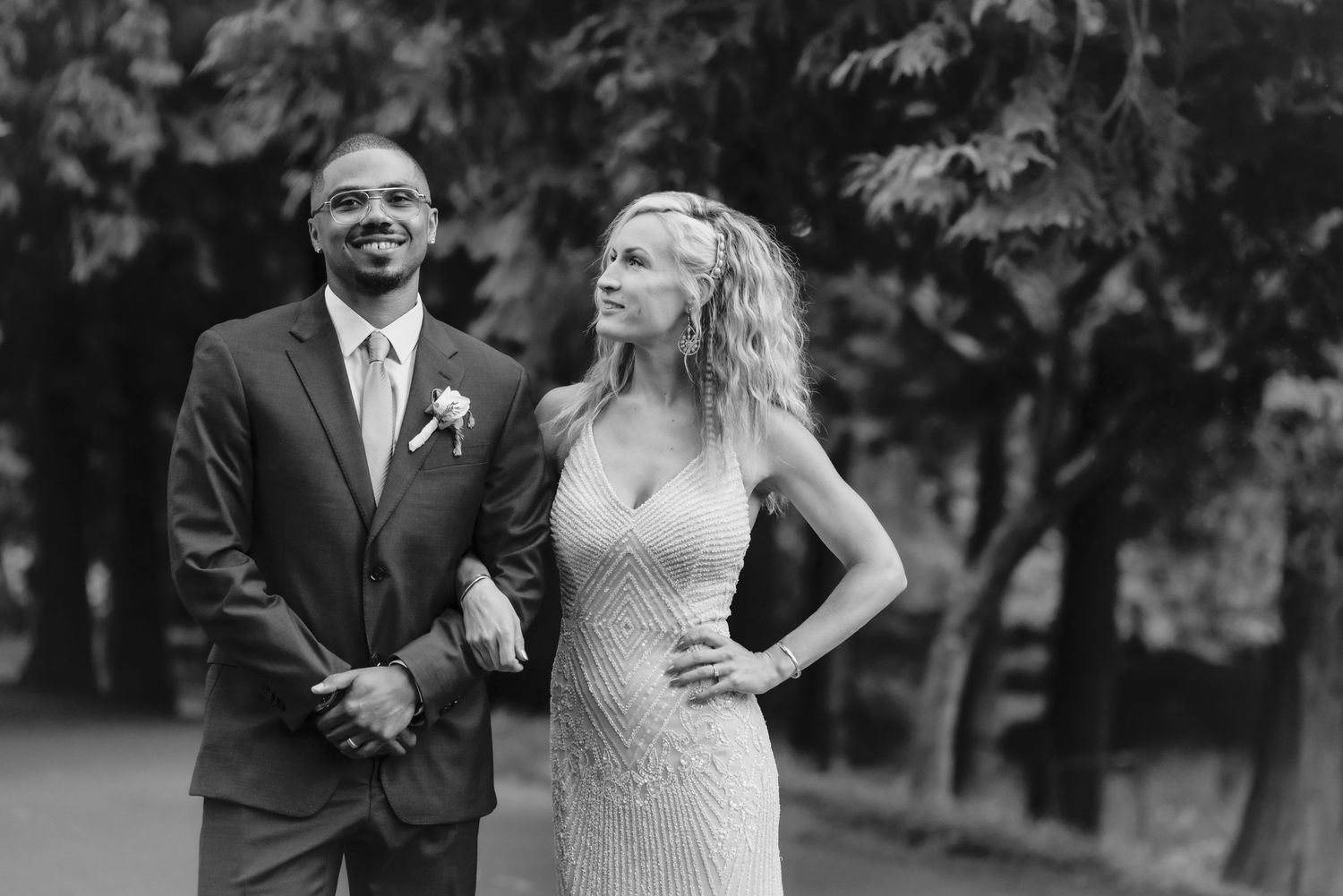 Black and white portrait of a stylish bride and groom showing their personalities during wedding photos.