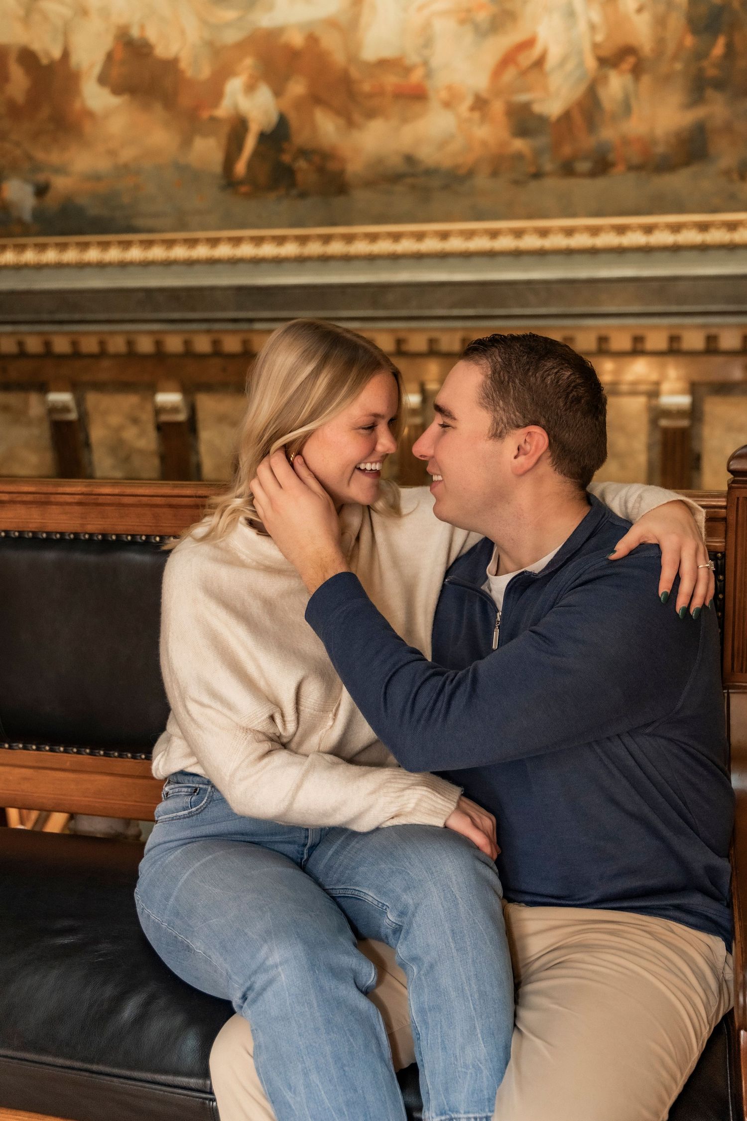 Couple laughing during engagement session on the 2nd Floor of the Iowa State Capital building.