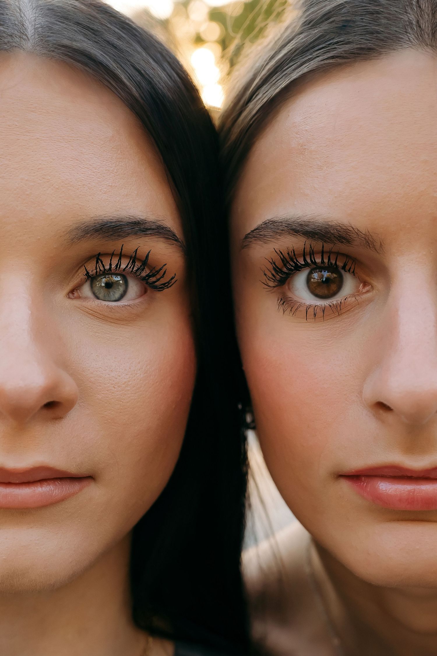 Close-up portrait of two women with striking eyes and long dark hair showing similar features and expressions.