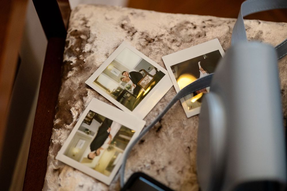 Vintage photographs scattered on a rustic wooden surface with distressed textures and warm lighting.