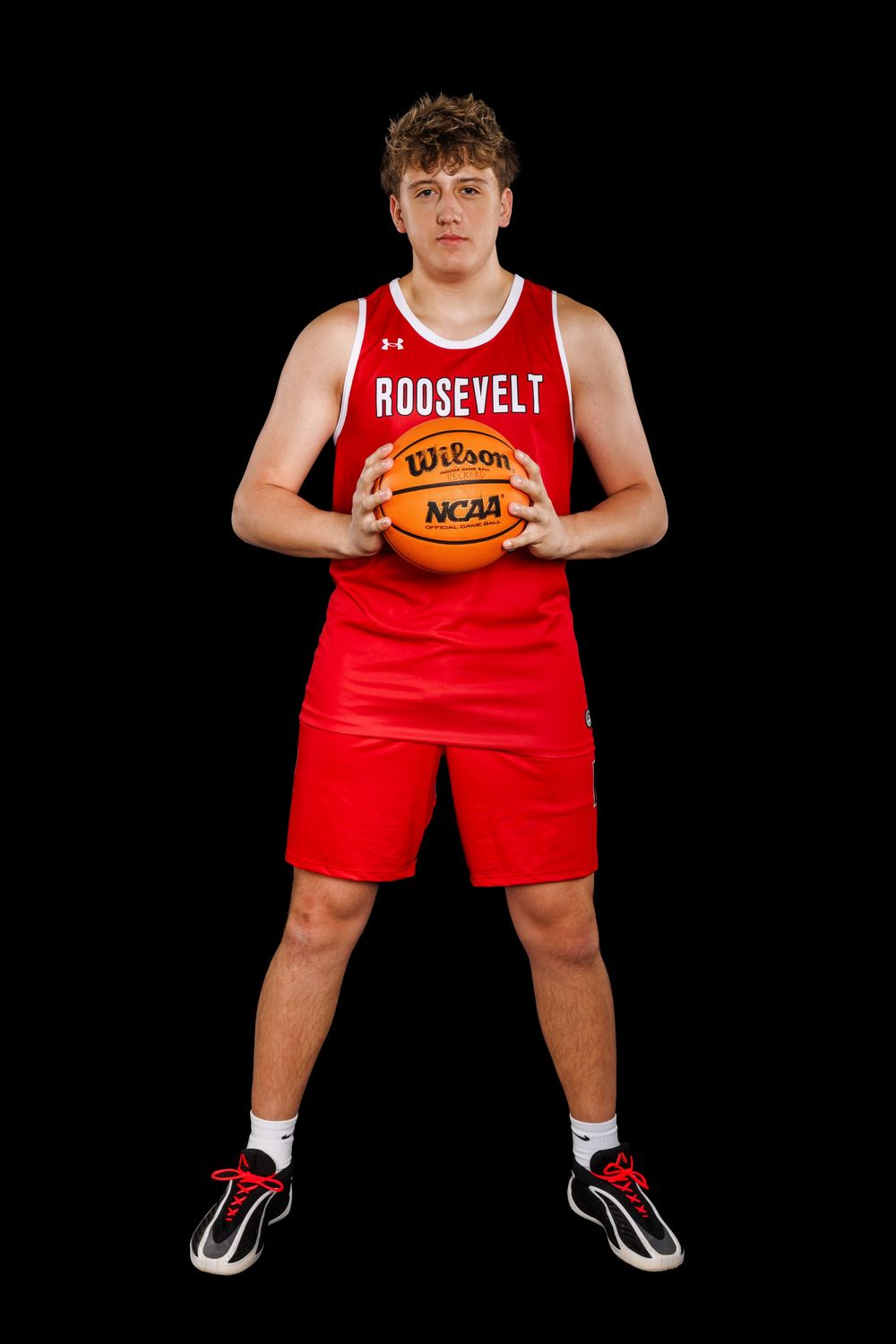 Basketball player in red Roosevelt uniform holds ball against black background in three similar posed shots.