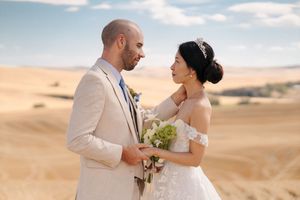 Romantic wedding photoshoot in a golden wheat field during sunset.
