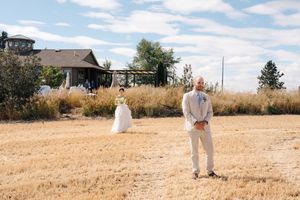 A series of panoramic shots showing a person in white clothing walking across a dry grassy field on a sunny day.