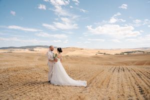 Panoramic wedding photos showing a couple posing in a vast harvested wheat field landscape.