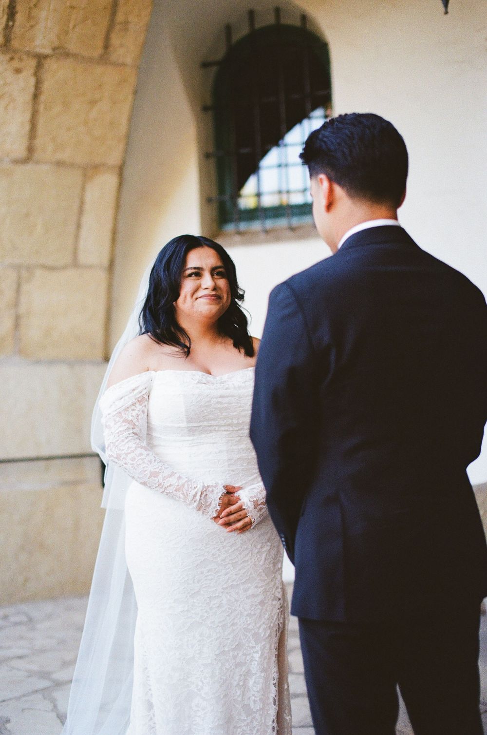 A 35mm film photo of a couple reciting their vows while eloping at the Santa Barbara Courthouse.