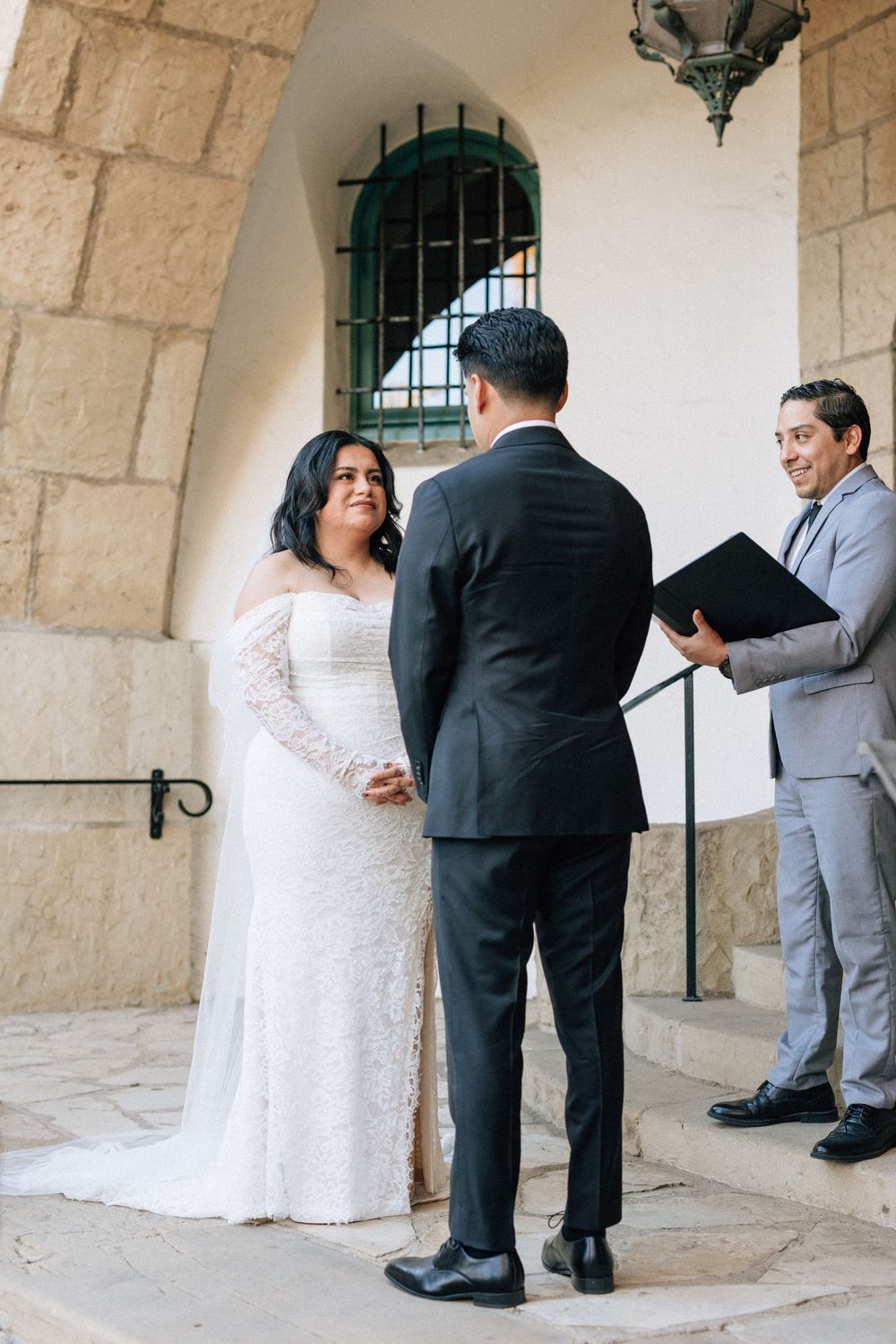 A bride recites vows at Santa Barbara Courthouse on the stone step area