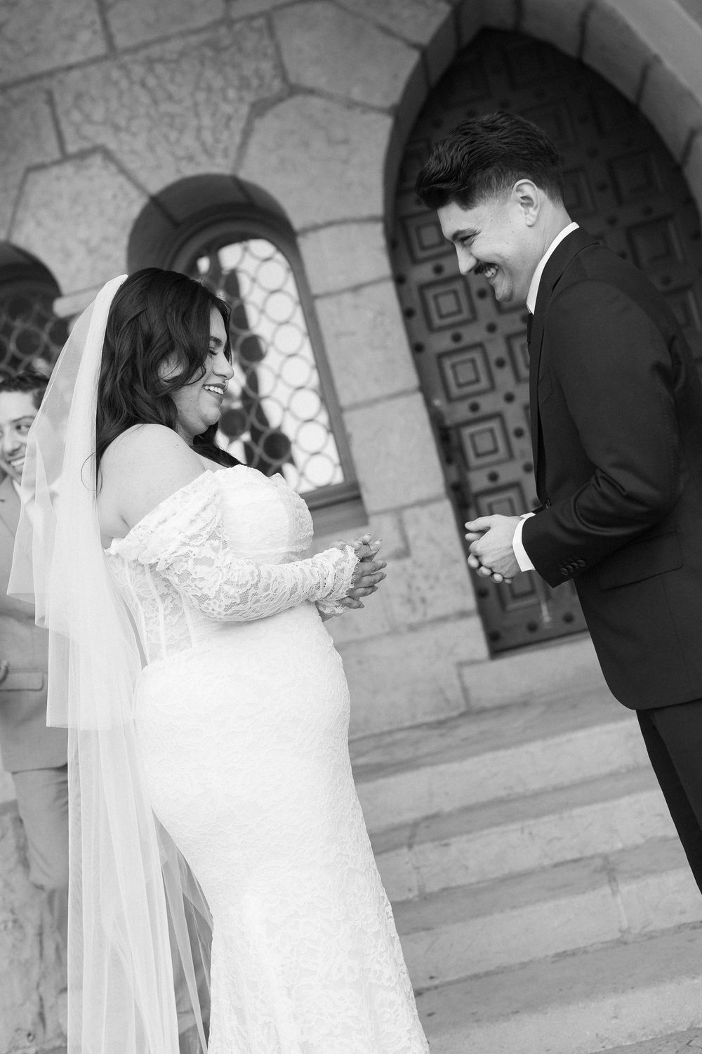 An artistic black and white photo of a couple exchanging vows on the staircase at the Santa Barbara Courthouse